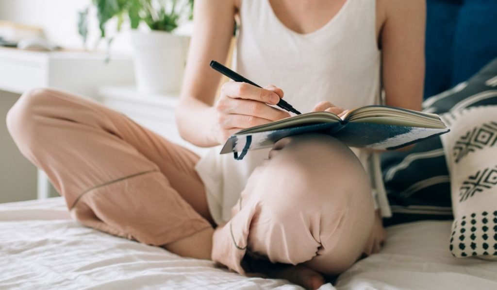 woman writing on her journal - ee220330