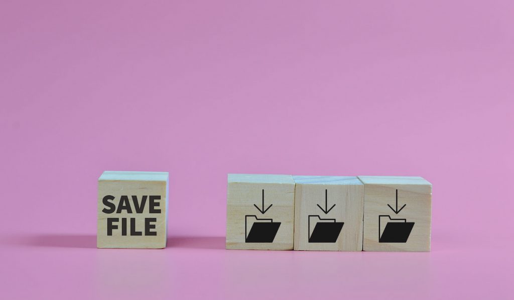 Wooden block with save file and save folder symbols uploading files