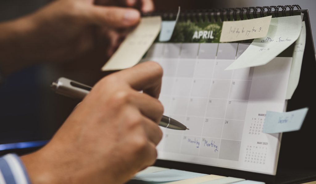 businessman checking memo and planning schedule on calendar planner 