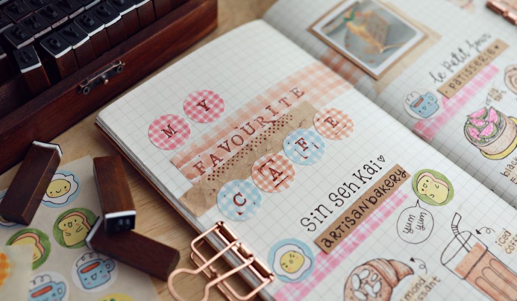 journal decorated with favorite café stickers