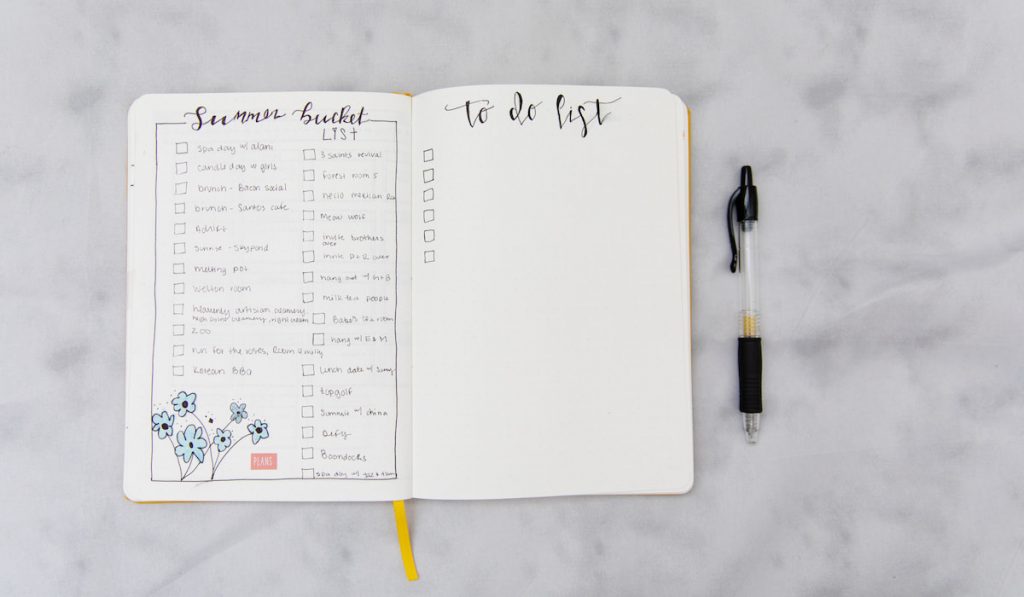Bucket list and to do list on a journal on gray background
