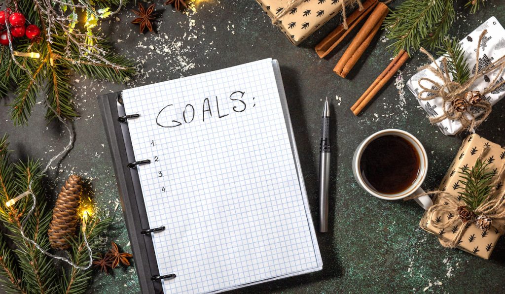 goal list journal using a grid notebook on a festive background