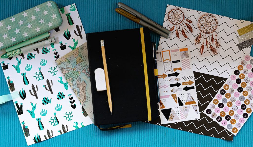 Bullet journal inspiration layouts with different materials, textures, colors and stationery sets.

