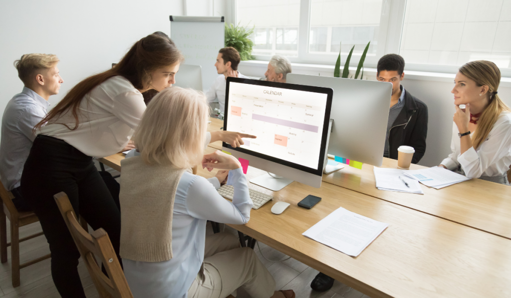 Young manager teaching senior worker